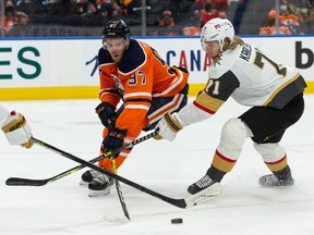 Edmonton Oilers' Connor McDavid (97) battles Las Vegas Golden Knights' Alex Pietrangelo (7) and William Karlsson (71) during first period NHL action at Rogers Place in Edmonton, on Tuesday, Feb. 8, 2022.