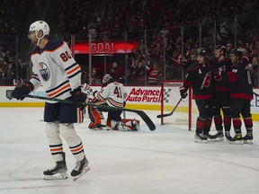 Carolina Hurricanes left wing Teuvo Teravainen (86) is congratulated by center Sebastian Aho (20)and  right wing Andrei Svechnikov (37) after his goal against the Edmonton Oilers at PNC Arena on Sunday, Feb. 27, 2022.