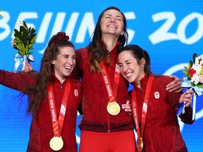 Gold medallists Ivanie Blondin, Valerie Maltais and Isabelle Weidemann of Team Canada pose with their medals during the Women's Team Pursuit medal ceremony on Day 11 of the Beijing 2022 Winter Olympic Games at Beijing Medal Plaza.