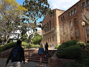 In this file photo taken on March 11, 2020, students walk on the campus of University of California at Los Angeles (UCLA) in Los Angeles, California.