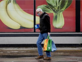 Shoppers leave an Edmonton grocery store on Wednesday, Feb. 9, 2022.