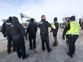 Authorities deal with a new road block at Highways 4 and 501 outside of Milk River heading towards the Coutts border crossing. Protesters were letting trucks through on one lane on Thursday, February 3, 2022.