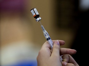 People are shown how to administer naloxone at the Street Works booth at the YEG Youth Connect event at the Boyle Street Plaza.