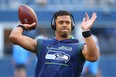Russell Wilson warms up before a pre-season game last year.