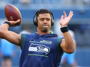 Russell Wilson warms up before a pre-season game last year.