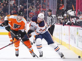 James van Riemsdyk (25) of the Philadelphia Flyers battles for control of the puck against Brad Malone (24) of the Edmonton Oilers at Wells Fargo Center on Tuesday, March 1, 2022, in Philadelphia, Pa.