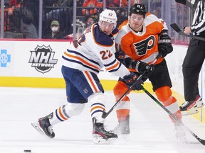 Tyson Barrie (22) of the Edmonton Oilers battles against Travis Konecny (11) of the Philadelphia Flyers at Wells Fargo Center on March 1, 2022, in Philadelphia, Pa.