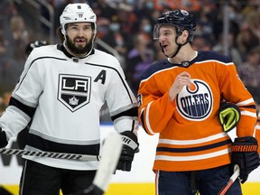 The Edmonton Oilers' Zach Hyman (18) chats with the Los Angeles Kings' Drew Doughty (8) at Rogers Place, in Edmonton on Dec. 5, 2021.
