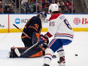 Edmonton Oilers’ goaltender Mike Smith (41) stops Montreal Canadiens’ Mathieu Perreault (85) during second period NHL action at Rogers Place in Edmonton, on Saturday, March 5, 2022.