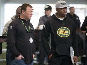 Edmonton Elks general manager and head coach Chris Jones, left, watches the Western Regional Canadian Football League combine alongside assistant GM Geroy Simon in Edmonton on March 18, 2022.