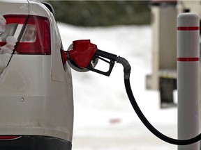 A motorist fills up with gas at the Capilano Esso station in Edmonton on Friday February 4, 2022. Gas prices at most pumps in the city jumped seven cents a litre overnight from $136.90 per litre to $143.90 per litre for regular gas.