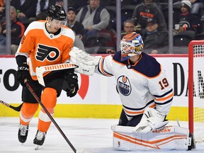 Edmonton Oilers goaltender Mikko Koskinen (19) holds away Philadelphia Flyers left wing Isaac Ratcliffe (76) after making a save at Wells Fargo Center.
