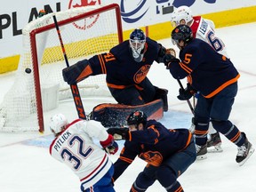 Edmonton Oilers' goaltender Mike Smith (41) stops Montreal Canadiens' Rem Pitlick (32) during third period NHL action at Rogers Place in Edmonton, on Saturday, March 5, 2022.