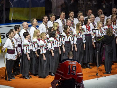 Edmonton Oilers goalie Mikko Koskinen (19) listens to a Ukrainian choir sing the national anthem prior to the game against the Washington Capitals on Wednesday, March 9, 2022 in Edmonton.
