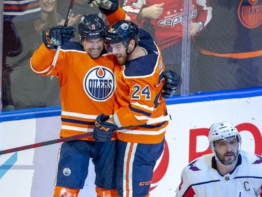 Edmonton Oilers Cody Ceci (5) celebrates his goal with teammate Brad Malone (24) as Washington Capitals Alex Ovechkin (8) skates away during second period NHL action on Wednesday, March 9, 2022 in Edmonton.