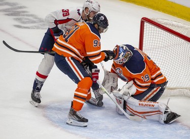Edmonton Oilers Evander Kane (91) and goalie Mikko Koskinen (19) keep the puck away from Washington Capitals Anthony Mantha during third period NHL action on Wednesday, March 9, 2022 in Edmonton.