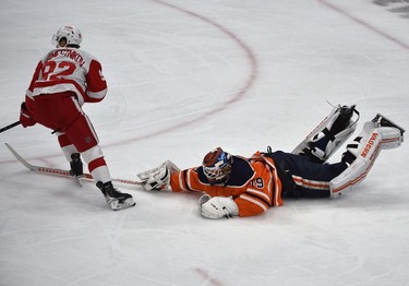 Edmonton Oilers goalie Mikko Koskinen (19) poke checked the puck off Detroit Red Wings Vladislav Namestnikov (92) who was on a break-away during NHL action at Rogers Place in Edmonton, March 15, 2022.