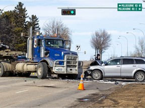 Police investigate a collision involving a semi truck carrying a load of metal pipe, and a SUV at the intersection of Millbourne Road East and 76 Street on Monday, March 21, 2022 in Edmonton.