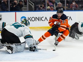 Edmonton Oilers' Connor McDavid (97) is stopped by  San Jose Sharks' goaltender Kaapo Kahkonen (34) during first period NHL action at Rogers Place in Edmonton, on Thursday, March 24, 2022.