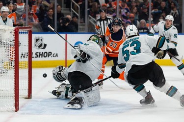 Edmonton Oilers' Ryan Nugent-Hopkins (93) is stopped by  San Jose Sharks' goaltender Kaapo Kahkonen (34) during first period NHL action at Rogers Place in Edmonton, on Thursday, March 24, 2022.