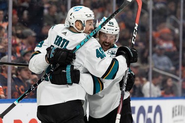 San Jose Sharks' Erik Karlsson (65) celebrates a goal with teammates on Edmonton Oilers' goaltender Mike Smith (41) during second period NHL action at Rogers Place in Edmonton, on Thursday, March 24, 2022.
