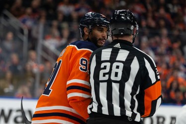 Edmonton Oilers' Evander Kane (91) chats with referee Chris Lee after receiving a penalty while playing the San Jose Sharks during first period NHL action at Rogers Place in Edmonton, on Thursday, March 24, 2022.
