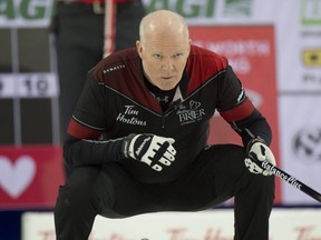 Ontario skip Glenn Howard crouches in the rings during Draw 1 against Team Canada at the Tim Hortons Brier in Lethbridge, Alta., Friday, March 4, 2022.