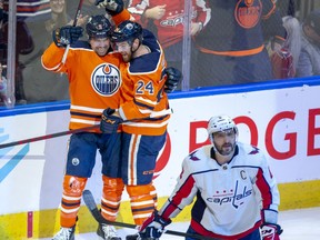 Edmonton Oilers Cody Ceci (5) celebrates his goal with teammate Brad Malone (24) as Washington Capitals Alex Ovechkin (8) skates away during second period NHL action on Wednesday, March 9, 2022 in Edmonton.