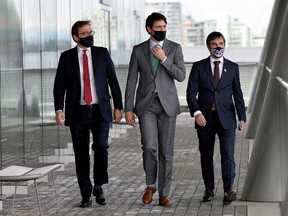Environment and Climate Change Minister Steven Guilbeault. left, Prime Minister Justin Trudeau and Natural Resources Minister Jonathan Wilkinson walk during the GLOBE Forum 2022 at the Vancouver Convention Centre on March 29, 2022.