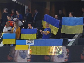 Edmonton Oilers fans wave Ukrainian flags during the National anthems at the game between the Edmonton Oilers and the Washington Capitals at Rogers Place, on Wednesday, March 9, 2022.