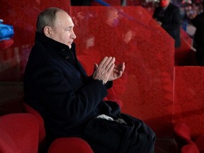 FILE PHOTO: Russian President Vladimir Putin applauds during a ceremony opening the 2022 Beijing Olympic Winter Games in Beijing, China February 4, 2022. Sputnik/Aleksey Druzhinin/Kremlin via REUTERS ATTENTION EDITORS - THIS IMAGE WAS PROVIDED BY A THIRD PARTY./File Photo
