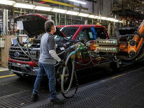 An assembly worker at Ford works on an F-series pickup truck at the Dearborn Truck Plant in Dearborn, Michigan, on Jan. 26, 2022.