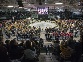 Family members and friends light candles during the Humboldt Broncos First Year Memorial service at Elgar Petersen Arena in Humboldt, Sask. on Saturday, April 6, 2019.
