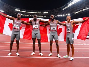 Aaron Brown of Canada, Jerome Blake of Canada, Brendon Rodney of Canada, and Andre De Grasse of Canada celebrates after winning bronze in the Men's 4 x 100m Relay Final during Olympic Games Day 14 at Olympic Stadium on August 6, 2021 in Tokyo, Japan.