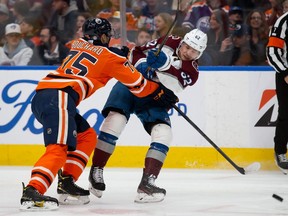 Evan Bouchard #75 of the Edmonton Oilers battles against Artturi Lehkonen #62 of the Colorado Avalanche during the third period at Rogers Place on April 9, 2022 in Edmonton, Canada.
