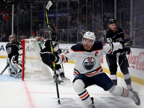 Connor McDavid (97) of the Edmonton Oilers celebrates his goal in front of Troy Stecher (51), Phillip Danault (24) and Jonathan Quick (32) of the Los Angeles Kings, to take a 1-0 lead at Crypto.com Arena on April 07, 2022, in Los Angeles, Calif.