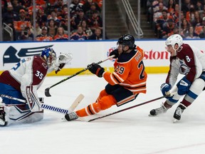 Edmonton Oilers’ Leon Draisaitl (29) is stopped by Colorado Avalanche goaltender Darcy Kuemper (35) during first period NHL action at Rogers Place in Edmonton, on Saturday, April 9, 2022.