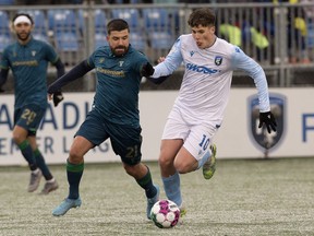 FC Edmonton's Tobias Warschewski (10) battles York United's Michael Petrasso (21) during Canadian Premier League action at Clark Field in Edmonton, Friday April 15, 2022.