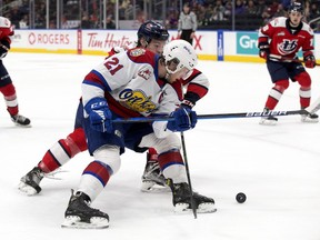 Edmonton Oil Kings captain Jake Neighbours (21) battles the Lethbridge Hurricanes' Chase Pauls (3) during second period WHL playoff action at Rogers Place in Edmonton, Saturday April 23, 2022.