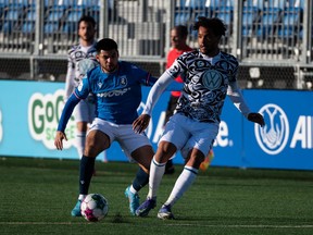 FC Edmonton’s Azriel Gonzalez (11) battles Pacific FC’s Abdoulaye Samake (5) during first half Canadian Premier League action at Clarke Stadium in Edmonton on Wednesday, April 27, 2022.