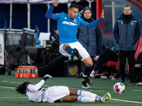 FC Edmonton’s Marcus Simmons (16) collides with Pacific FC’s Georges Mukumbilwa (2) during second half Canadian Premier League action at Clarke Stadium in Edmonton on Wednesday, April 27, 2022.