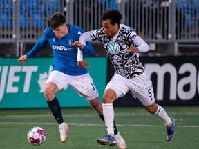 FC Edmonton’s Tobias Warschewski (10) battles Pacific FC’s Abdoulaye Samake (5) during second half Canadian Premier League action at Clarke Stadium in Edmonton, on Wednesday, April 27, 2022.