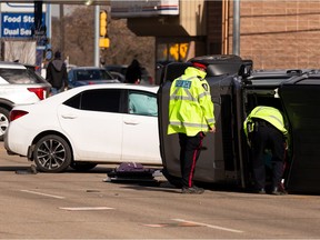 Edmonton Police Service officers investigate a two-car crash at 93 Street and 103A Avenue in Edmonton, on Thursday, Nov. 28, 2022.