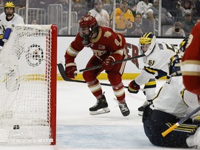 Denver forward Carter Savoie (8) scores the game winning goal during overtime of their 3-2 win over Michigan in the 2022 Frozen Four college ice hockey national semifinals at TD Garden on April 7, 2022.