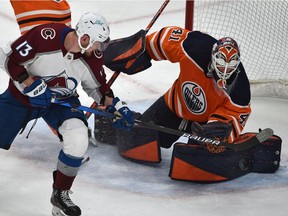 Edmonton Oilers goalie Mike Smith (41) gets up a rebound as Colorado Avalanche Valeri Nichushkin (13) tries to get a handle on it at Rogers Place in Edmonton on April 22, 2022.