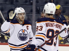 Edmonton Oilers center Connor McDavid (97) celebrates with teammate Ryan Nugent-Hopkins (93) after scoring a power-play goal against the Pittsburgh Penguins at PPG Paints Arena on Tuesday, April 26, 2022.