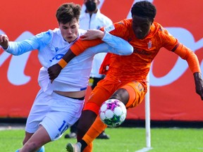 Edmonton FC striker Tobias Warschewski battles for the ball with Forge FC defender Kwasi Poku in CPL play at Tim Hortons Field in Hamilton, Ont., on April 23, 2022.
