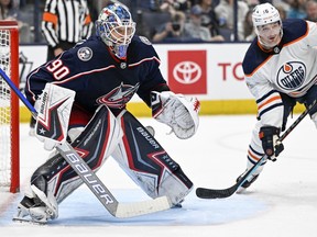 Columbus Blue Jackets goaltender Elvis Merzlikins (90) follows the puck as Edmonton Oilers center Derick Brassard (16) looks to deflect a shot in the second period at Nationwide Arena on April 25, 2022.