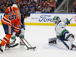 Vancouver Canucks goaltender Spencer Martin (30) makes a save on a shot by Edmonton Oilers forward Kailer Yamamoto (56) during the third period at Rogers Place.