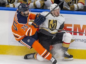 Edmonton Oilers Evan Bouchard (75) collides with Vegas Golden Knights Evgenii Dadonov (63) during second period NHL action on Saturday, April 16, 2022 in Edmonton.